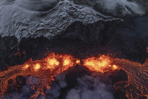 An aerial view of volcanic activity on the active volcano in Grindavik on Iceland's Reykjanes Peninsula, Tuesday, Dec. 19, 2023. (AP Photo/Marco Di Marco)