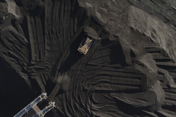 A bulldozer moves coal Thursday, April 10, 2025, in Princeton, Ind. (AP Photo/Joshua A. Bickel)