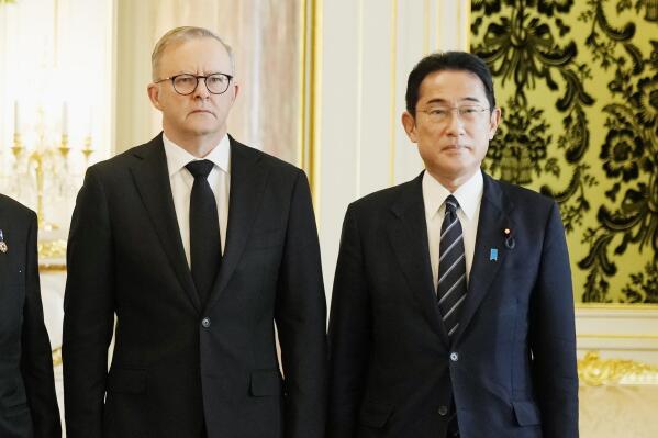 FILE - Australian Anthony Albanese, left, poses for a photo with Japanese Prime Minister Fumio Kishida before their meeting at the Akasaka Palace state guest house in Tokyo on Sept. 27, 2022. Albanese said Wednesday, Oct. 19, he will discuss with his Japanese counterpart Fumio Kishida strengthening their bilateral defense and security partnership to counter a more assertive China when the leaders meet in Australia this week. (AP Photo/Hiro Komae, Pool, File)