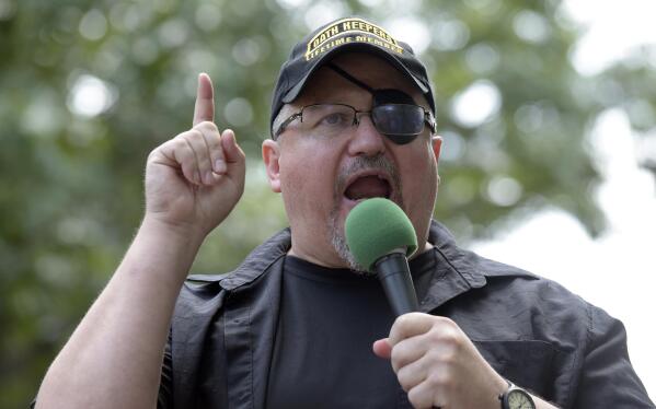 FILE - Stewart Rhodes, founder of the Oath Keepers, speaks during a rally outside the White House in Washington, June 25, 2017. In his trial in the violent Jan. 6, 2021 attack on the U.S. Capitol, attorneys for the leader of the Oath Keepers extremist group will mount an unusual defense with former President Donald Trump at its center. Defense attorneys are poised to argue that Rhodes can’t be found guilty of seditious conspiracy because everything he did was in preparation for orders he anticipated coming down from the Republican president. (AP Photo/Susan Walsh, File)