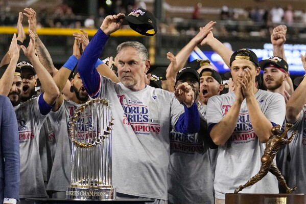 Texas Rangers manager Bruce Bochy celebrates with the trophy after winning Game 5 of the baseball World Series against the Arizona Diamondbacks Wednesday, Nov. 1, 2023, in Phoenix. The Rangers won 5-0 to win the series 4-1. (AP Photo/Brynn Anderson)