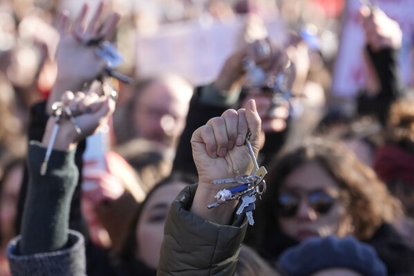 Women show keys as they gather on the occasion of International Day for the Elimination of Violence against Women, in Milan, Italy, Saturday, Nov.25, 2023. Thousands of people are expected to take the streets in Rome and other major Italian cities as part of what organizers call a "revolution" under way in Italians' approach to violence against women, a few days after the horrifying killing of a college student allegedly by her resentful ex-boyfriend sparked an outcry over the country's "patriarchal" culture. (AP Photo/Luca Bruno)