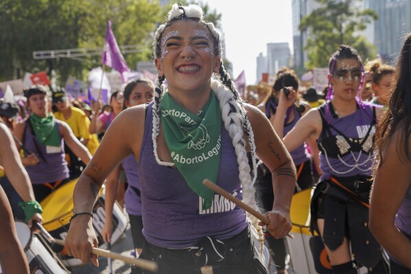 Women play their drums as they march against gender-based violence marking International Women's Day, in Mexico City, Friday, March 8, 2024. (AP Photo/Aurea del Rosario)