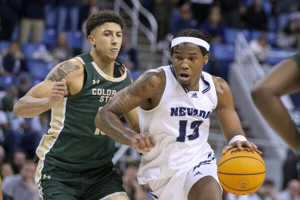 Nevada guard Kenan Blackshear (13) drives against Colorado State guard Nique Clifford during the second half of an NCAA college basketball game Wednesday, Jan. 24, 2024, in Reno, Nev. (APPhoto/Tom R. Smedes)