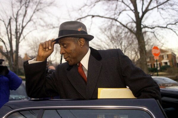 FILE - In This Jan. 27, 1998 file photo, Vernon Jordan, long-time confidant of President Clinton, leaves his home in Washington.  Jordan, who rose from humble beginnings in the segregated South to become a champion of civil rights before reinventing himself as a Washington insider and corporate influencer, died Tuesday, March 2, 2021, according to a statement from his daughter. He was 85. (AP Photo/Khue Bui, File)