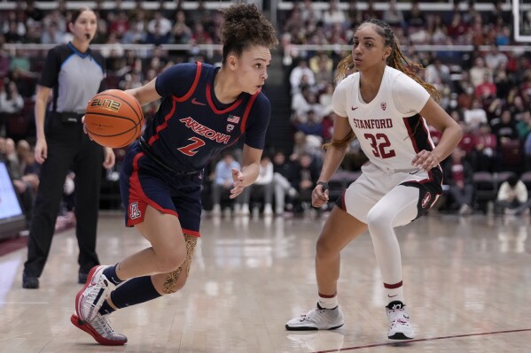 Arizona guard Jada Williams (2) drives to the basket against Stanford guard Jzaniya Harriel (32) during the first half of an NCAA college basketball game in Stanford, Calif., Friday, Feb. 23, 2024. (AP Photo/Jeff Chiu)
