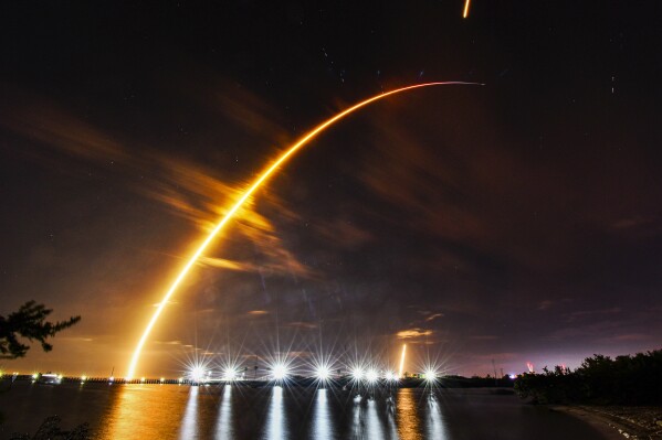 A SpaceX Falcon 9 rocket is launched from a pad at Kennedy Space Center, seen from Port Canaveral, Fla. Thursday, Feb. 15, 2024. (Malcolm Denemark/Florida Today via AP)