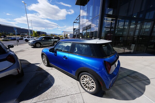 FILE - Unsold 2025 Countryman sports-utility vehicles and Cooper S hardtops sit on display at a Mini dealership Oct. 21, 2024, in Highlands Ranch, Colo. (AP Photo/David Zalubowski, File)