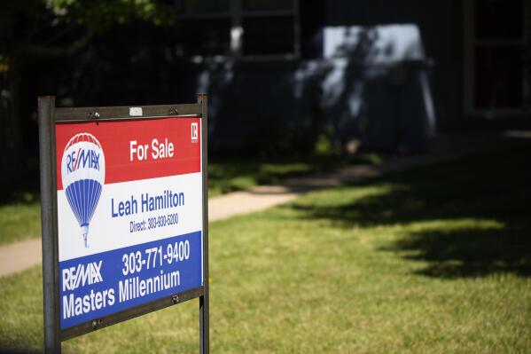 A sale sign stands outside a home on the market Tuesday, Sept. 21, 2021, in southeast Denver. The National Association of Realtors releases existing home sales for August on Wednesday, Sept. 22. (AP Photo/David Zalubowski)