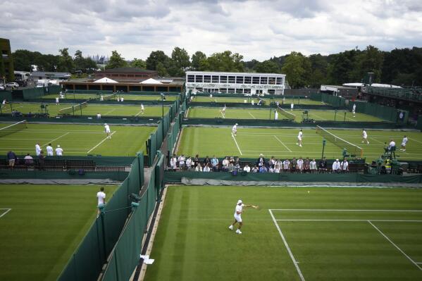 Rafael Nadal of Spain, bottom right, attends a practice session ahead of the 2022 Wimbledon Championship at the All England Lawn Tennis and Croquet Club, Wimbledon, England in London, Friday, June 24, 2022. (AP Photo/Kirsty Wigglesworth)