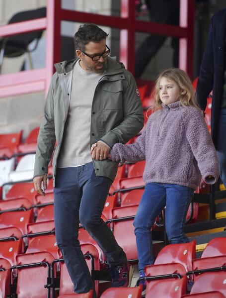Wrexham co-owner, actor Ryan Reynolds arrives with his daughter, prior to the English FA Cup 4th round Soccer match between Wrexham and Sheffield United at The Racecourse Ground, in Wrexham, England, Sunday, Jan. 29, 2023. (Peter Byrne/PA via AP)