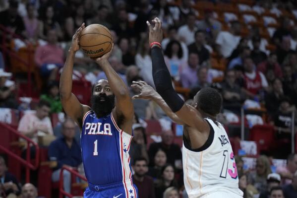 Philadelphia 76ers guard James Harden (1) takes a shot against Miami Heat center Bam Adebayo (13) during the first half of an NBA basketball game, Wednesday, March 1, 2023, in Miami. (AP Photo/Wilfredo Lee)
