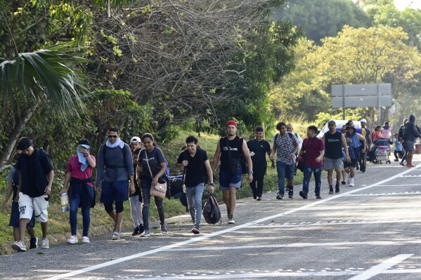 Migrants walk along a highway in Huixtla, Mexico, Monday, Dec. 25, 2023. A caravan of migrants set out north through southern Mexico just days before U.S. Secretary of State Antony Blinken arrives in Mexico City to discuss new agreements to control the surge of migrants seeking entry into the United States. (AP Photo/Edgar H. Clemente)