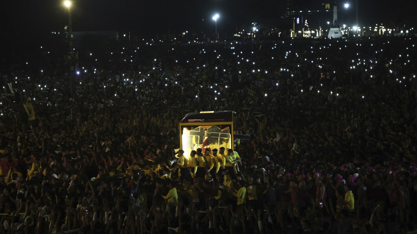 Filipino Catholics pray for good health and peace in huge procession venerating Jesus statue