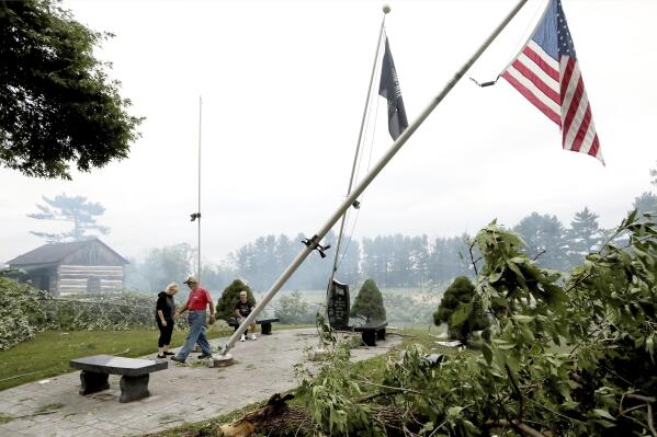 Jefferson County residents inspect damage at Dahnert Park, Thursday, July 29, 2021 in Concord, Wis., following an overnight storm. (John Hart/Wisconsin State Journal via AP)