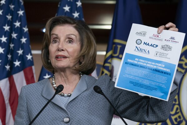 Speaker of the House Nancy Pelosi, D-Calif., displays an advocacy ad that criticizes the tobacco and vaping industry for allegedly targeting young African-Americans, during a news conference on Capitol Hill in Washington, Thursday, Feb. 27, 2020. The House is voting on a measure to reverse the tobacco epidemic among young people. (AP Photo/J. Scott Applewhite)