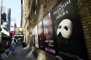 REMOVES REFERENCE TO HAMILTON - FILE - Broadway posters outside the Richard Rodgers Theatre in New York on May 13, 2020. Broadway theaters may be dark but there will be plenty of new online productions of some of classic plays this fall. Jeffrey Richards on Wednesday unveiled a seven weekly play run of livestreamed works to benefit The Actors Fund. They will stream on Broadway’s Best Shows and ticket buyers can access the events through TodayTix starting at $5. The plays include “The Best Man,” “This Is Our Youth,” Time Stands Still” and “Race” (Photo by Evan Agostini/Invision/AP, File)