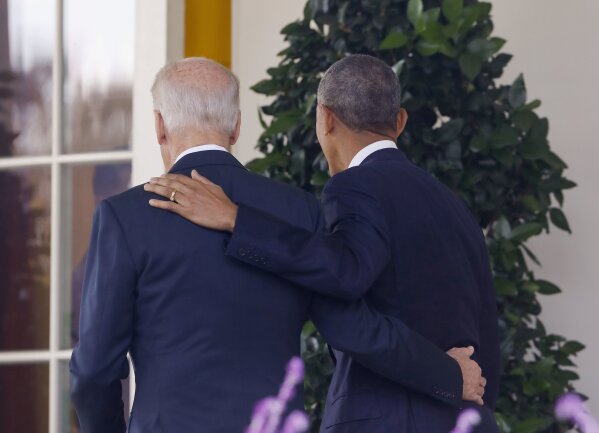 FILE - In this Nov. 9, 2016, file photo, President Barack Obama and Vice President Joe Biden, with their arms on each other, walk back to the Oval Office of the White House in Washington, after the president spoke about the election in the Rose Garden. Nearly eight years after he was last on the ballot, Obama is emerging as a central figure in the 2020 presidential election. Democrats are eagerly embracing Obama as a political wingman for Joe Biden, who spent two terms by his side as vice president. Obama remains the party’s most popular figure, particularly with black voters and younger Democrats. (AP Photo/Pablo Martinez Monsivais, File)