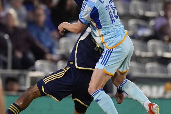 Vancouver Whitecaps midfielder Pedro Vite, left, gets tangled up with Colorado Rapids midfielder Oliver Larraz in the first half of an MLS soccer match Wednesday, May 15, 2024, in Commerce City, Colo. (AP Photo/David Zalubowski)