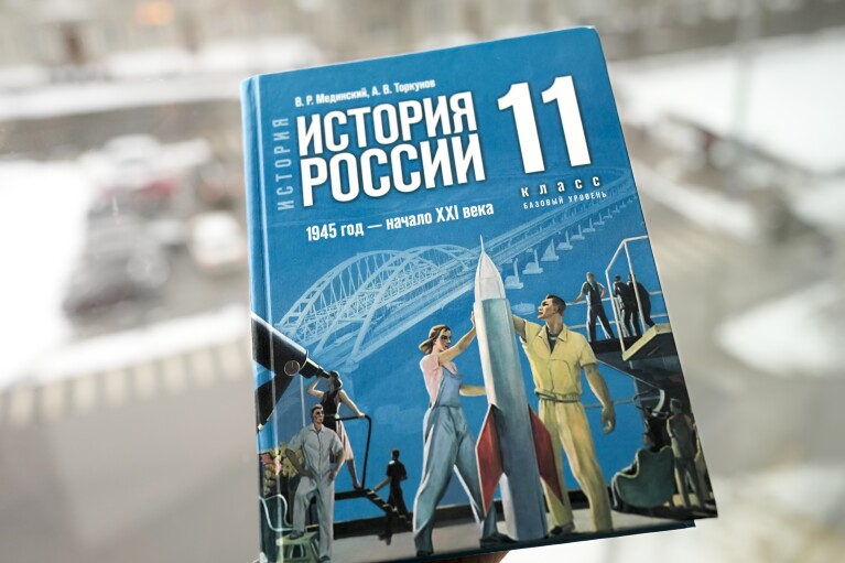 A view of a Russian history textbook for schools with a sign on the cover reads "Russian history. 1945 year - beginning of the 21st century. Grade 11. A basic level", in Tallinn, Estonia, Tuesday, Feb. 13, 2024. In Russia, history has long become a propaganda tool used to advance the Kremlin's political goals. In an effort to rally people around the flag, the authorities have sought to magnify the country's past victories while glossing over the more sordid chapters. A new history textbook released by authorities last year featured a chapter on Moscow's "special military operation" in Ukraine and described the collapse of the Soviet Union as "the greatest geopolitical catastrophe of the 20th century." (AP Photo)