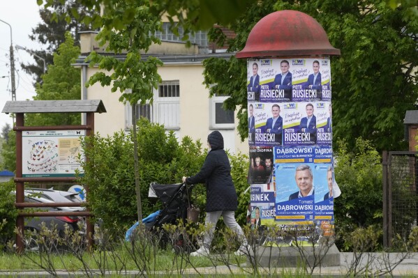 Campaign posters promote candidates as Poles vote in local and regional elections in Lomianki, near Warsaw, Poland on Sunday, April 21, 2024. Voters are choosing mayors who did not win outright in the first round of the election two weeks earlier. (AP Photo/Czarek Sokolowski)