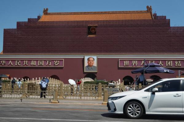 Security personnel stand on duty near the Tiananmen Gate which is under renovation on the anniversary of China's bloody 1989 crackdown on pro-democracy protests in Beijing, Wednesday, June 4, 2025. (AP Photo/Ng Han Guan)