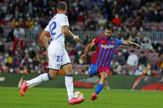Barcelona's Sergio Aguero takes a shot during the La Liga soccer match between Barcelona and Alaves at the Camp Nou stadium in Barcelona, Spain Saturday, Oct. 30, 2021. (AP Photo/Joan Monfort)