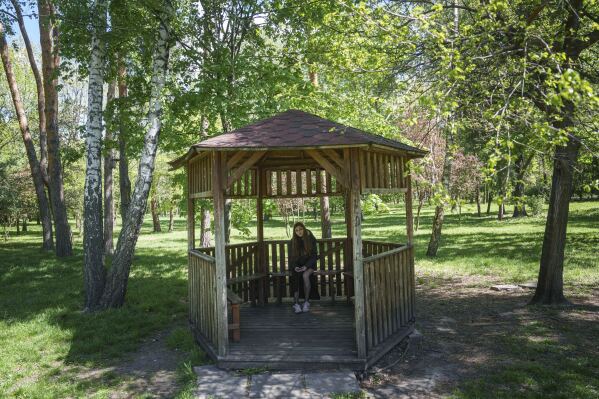 Alyona Zavadska, 16, sits in a gazebo where she had her first date with boyfriend Danylo Khudia, 17, who was killed in a Russian strike on April 24, in Kyiv, Ukraine, on Sunday, April 27, 2025. (AP Photo/Evgeniy Maloletka)
