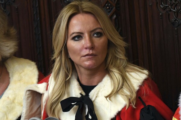 FILE - Baroness Michelle Mone looks on ahead of the State Opening of Parliament by Queen Elizabeth II, in the House of Lords at the Palace of Westminster in London, June 21, 2017. A member of Britain’s House of Lords has acknowledged that she repeatedly lied about her links to a company that was awarded lucrative government contracts to supply protective masks and gowns during the coronavirus pandemic. Underwear tycoon Michelle Mone said she had made an “error” in denying connections to the company PPE Medpro and regretted threatening to sue journalists who alleged she had ties to the firm. (Stefan Rousseau/PA Wire/PA via AP, File)