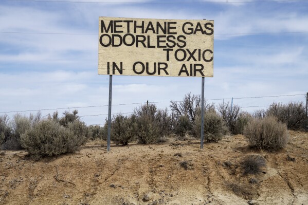 A sign protesting emissions from oil and gas stands across from Lybrook Elementary School, in Counselor, N.M., Navajo Nation, on Tuesday, March 11, 2025. (Nadav Soroker/Searchlight New Mexico via AP)