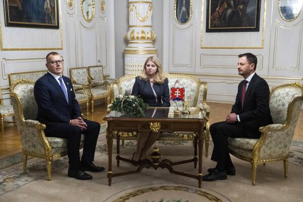 Slovakia's Prime Minister Eduard Heger, right, and House Chair Boris Kollar, left, meet Slovakia's President Zuzana Caputova, after Parliament where a vote expressed no-confidence in Heger's Government, at the Presidential Palace, in Bratislava, Thursday, Dec. 15, 2022. Slovakia’s coalition government has fallen after losing a parliamentary no-confidence vote. In the country's 150-seat parliament, 78 lawmakers, two more than 76 needed, voted to oust the three-party minority government of Prime Minister Eduard Heger on Thursday. President Zuzana Caputova will have to appoint a new prime minister. (Jaroslav Novak/TASR via AP)