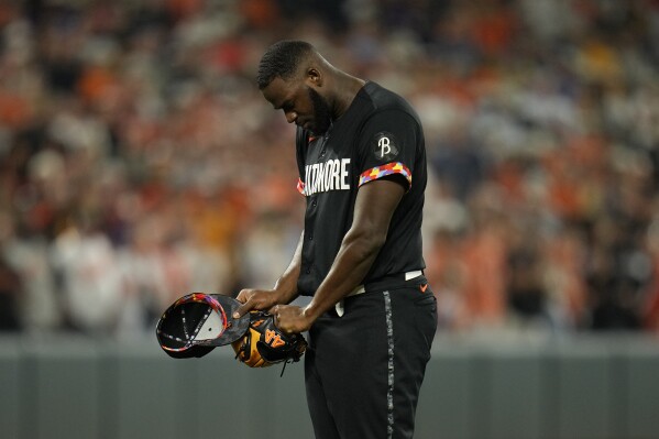 Baltimore Orioles relief pitcher Felix Bautista reacts after a pitch against the Colorado Rockies during the ninth inning of a baseball game, Friday, Aug. 25, 2023, in Baltimore. The Orioles won 5-4. Bautista left the game after the pitch. (AP Photo/Julio Cortez)