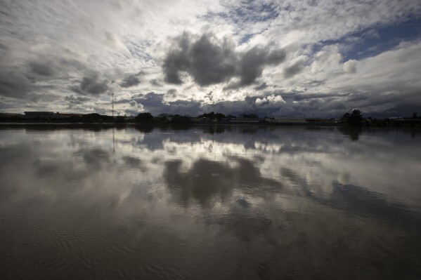 The clouds are reflected in the Whanganui river of the city of Whanganui, New Zealand, June 17, 2022. (AP photo / Brett Phibbs, file)