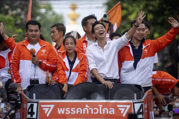 Pita Limjaroenrat, wearing white shirt, leader of Move Forward Party, waves to his supporters, in Bangkok, Monday, May 15, 2023. Fresh off a stunning election victory in which they together captured a majority of seats in the House of Representatives, Thailand's top two opposition parties began planning Monday for the next stage in their bid to replace the military-dominated government. (AP Photo/Wason Wanichakorn)