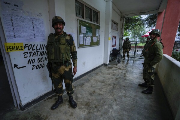 Paramilitary soldiers guard a polling station during the first round of polling of India’s national election in Doda district, Jammu and Kashmir, India, Friday, April 19, 2024. (AP Photo/Channi Anand)