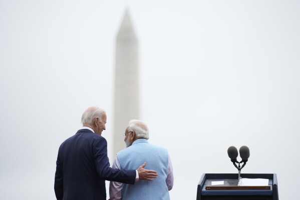President Joe Biden speaks with India's Prime Minister Narendra Modi during a State Arrival Ceremony on the South Lawn of the White House in Washington, Thursday, June 22, 2023. The Washington Monument is seen in the distance. (AP Photo/Andrew Harnik)