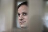 FILE - Wall Street Journal reporter Evan Gershkovich stands in a glass cage in a courtroom at the Moscow City Court in Moscow, Russia, Oct. 10, 2023. (AP Photo/Alexander Zemlianichenko, File)