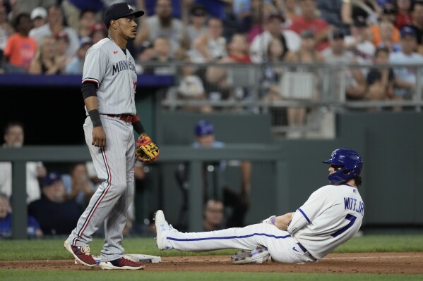 Kansas City Royals' Bobby Witt Jr. (7) slides to third after hitting a triple during the seventh inning of a baseball game Saturday, July 29, 2023, in Kansas City, Mo. (AP Photo/Charlie Riedel)