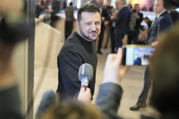 FILE - Ukrainian President Volodymyr Zelenskyy talks to reporters after a meeting at the Annual Meeting of World Economic Forum in Davos, Switzerland, Jan. 16, 2024. Ukrainian President Volodymyr Zelenskyy says he's worried by the prospect of Donald Trump returning to the White House. In an interview with the U.K.’s Channel 4 News that aired Friday Jan. 19, 2024, Zelenskyy called Trump’s claim that he could stop Ukraine’s war with Russia in 24 hours “very dangerous.” (AP Photo/Markus Schreiber, File)