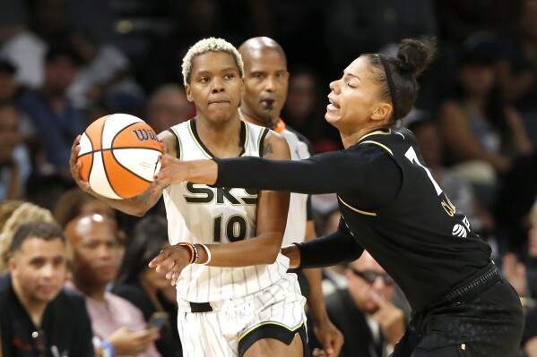 Las Vegas Aces forward Alysha Clark (7) steals the ball from Chicago Sky guard Courtney Williams (10) during the first half of Game 2 of a WNBA basketball playoff series game, Sunday, Sept. 17, 2023, in Las Vegas. (Steve Marcus/Las Vegas Sun via AP)