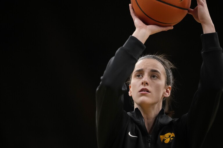 Iowa guard Caitlin Clark warms up for the team's NCAA college basketball game against Michigan, Thursday, Feb. 15, 2024, in Iowa City, Iowa. (AP Photo/Matthew Putney)