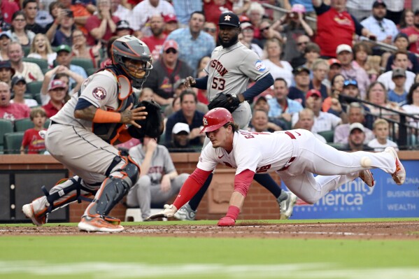 St. Louis Cardinals second baseman Nolan Gorman (16) slides safety into home in the first inning against the Houston Astros during a baseball game Wednesday, June 28, 2023, in St. Louis. (AP Photo/Michael Thomas)