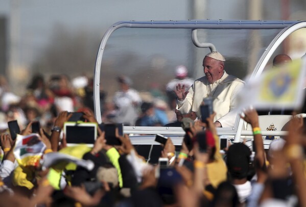 Pope Francis waves at faithful as he arrives for a massive open-air Mass in a park just a few meters from the U.S. border in Ciudad Juarez, Mexico, Feb. 17, 2016. (AP Photo/Dario Lopez-Mills)