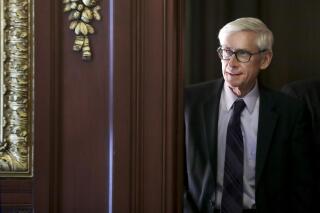 FILE - In this March 21, 2019 file photo, Governor Tony Evers arrives to a ceremony at the State Capitol in Madison, Wis. Gov. Evers made it official Saturday, June 5, 2021, announcing his bid for a second term in the battleground state where he stands as a Democratic block to the Republican-controlled state Legislature.(Steve Apps/Wisconsin State Journal via AP)