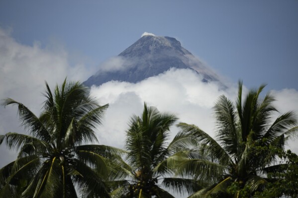 Mayon Volcano is seen from Guinobatan, Albay province, northeastern Philippines, Monday, June 12, 2023. The Philippines' most active volcano was gently spewing lava down its slopes Monday, alerting tens of thousands of people they may have to quickly flee a violent and life-threatening explosion. (AP Photo/Aaron Favila)