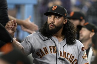 San Francisco Giants starting pitcher Sean Manaea looks over in the dugout before a baseball game against the Los Angeles Dodgers in Los Angeles, Sept. 22, 2023. Manaea became the latest pitcher to join the revamped rotation of the New York Mets, agreeing to a $28 million, two-year contract, a person familiar with the agreement told The Associated Press. The person spoke on condition of anonymity Sunday, Jan. 7, 2024 because the agreement was subject to a successful physical. (AP Photo/Alex Gallardo)