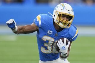 FILE - Los Angeles Chargers running back Austin Ekeler carries the ball during the second half of an NFL football game against the Los Angeles Rams Sunday, Jan. 1, 2023, in Inglewood, Calif. Chargers running back Austin Ekeler could be on his way out. Ekeler’s agent, Cameron Weiss, said on Tuesday, March 14, 2023, that the team has given Ekeler permission to seek a trade after both sides could not agree on a contract extension.(AP Photo/Mark J. Terrill, File)