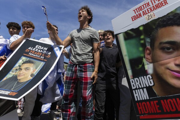 People gathered in Huyler Park celebrate the release of American hostage Edan Alexander from Hamas on Monday, May 12, 2025, in Tenafly, N.J. (AP Photo/Stefan Jeremiah)