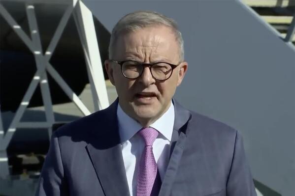 In this image from a video, Australian Prime Minister Anthony Albanese speaks to reporters ahead of his departure in Perth, Australia Wednesday, March 8, 2023. Albanese said Wednesday he plans to meet with President Joe Biden in the United States following a trip to India this week, amid speculation the leaders will make an announcement about Australia's plans to build nuclear submarines. (Australia Pool via AP)