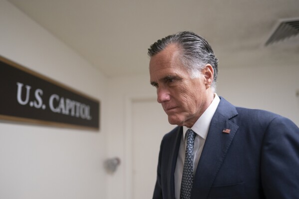 FILE - Sen. Mitt Romney, R-Utah, a member of the Senate Foreign Relations Committee, heads to a vote before a national security briefing on Ukraine, at the Capitol in Washington, March 16, 2022. Romney will not run for reelection in 2024. The former presidential candidate and Massachusetts governor announced his intentions in a video statement Wednesday. (AP Photo/J. Scott Applewhite, File)